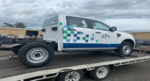 A white car on a car carrier